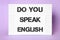 Stand with question Do You Speak English on violet background