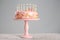 Stand with tasty birthday cake and burning candles on table
