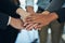 Stand together, win together. Cropped shot of a group of businesspeople joining their hands in solidarity.