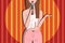 Stand up female comedian speaking a live show. Woman with microphone on a scene. Red curtain on background. Yellow