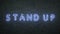 Stand Up neon sign on black brick wall background