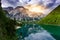 Stand up paddle board on Lake Braies (also known as Pragser Wildsee or Lago di Braies) in Dolomites Mountains, Sudtirol, Italy.