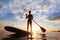 Stand-up paddle, paddle standing, silhouette of man on the beach