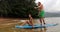 Stand up paddleboard - couple on paddle board in ocean watersport activity