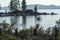 Stand up paddleboard floating and boats anchored near a beach at sunset in lake tahoe