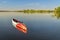 Stand up paddleboard is floating on a calm lake