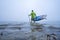 Stand up paddler on a foggy lake