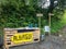 Stand with water for pilgrims on the way to Santiago de Compostela, with a yellow sign to the next albergue