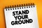 Stand Your Ground text on notepad, concept background