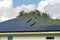 Standard american residential house with rooftop covered with solar photovoltaic panels for producing of clean