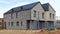 Standard unfinished symmetrical two-story rural  home  for four young families