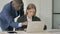 Standing African Businessman Helping Female Employee at Work, Guiding