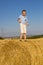 Standing on a bale of hay