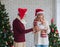 Standing beautiful Caucasian senior woman feel happy receiving Christmas gift from her husband during celebrating Christmas and