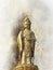 Standing Buddha statue and softly blurred watercolor background