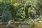 Standing Dolphins Spitting Water Through Their Recreated Mouth In A Fern Sculpture.