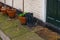 Standing high waders with beautiful brown pots at the entrance t