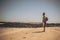 Standing man enjoying the desert traveling with a backpack - lonely people in the wild . men and outdoor nature traveling activity