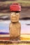 Standing moai with red stone hat and large eyes in Easter Island, Chil