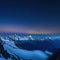 standing on mountaintop at night under clouds at sky