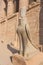 Standing next to the bird statue of Horus