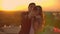 Standing on the roof at sunset a married couple a man and a woman hug and take a selfie on the phone. Take pictures of