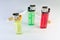 standing three multicolored disposable flint gas lighters and two filter cigarettes
