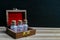 Standing vintage glass bottles of homeopathic pills in old open wooden box on dark and wood background