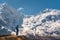 Standing young woman on the hill and looking on amazing Himalaya