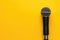 Standout microphone on a vibrant yellow background, adding a pop of color to any presentation, Ai Generated