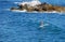 Standup paddle boarder surfing off Heisler Park, Laguna Beach, California.