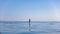 A standup paddleboarding, supsurfing man in the Adriatic sea in Croatia