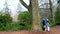 stanley park teen walking taking pictures fooling around looking at trees chatting spring cool weather tourists