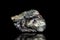 Stannite, tin and copper iron ore, raw rock on black background, mining and geology