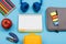 Stapler, apple, color pencils, headphones, notebook, lunch box a