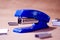 Stapler. Stapler blue. Stapler and staples. Stapler is on the table. Office. Office stapler