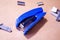 Stapler. Stapler blue. Stapler and staples. Stapler is on the table. Office. Office stapler