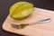 Star apple and fork on wooden block. Fresh star apple fruit and fork on wood table.
