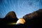 Star circles above the mountains and a glowing camping tent