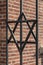 Star of David on metal fence of Old Synagogue in Cracow , Poland