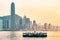 Star ferry at Victoria Harbor and Hong Kong skyline at sundown