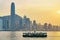 Star ferry at Victoria Harbor and Hong Kong skyline at sundown