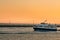 Star Line ferry leaving Mackinac Island harbor in front of the Mackinac Bridge at sunset