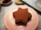 Star shaped chocolate cake, sprinkled with cocoa powder