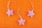 Star shaped Christmas tree decorations on orange hessian