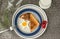Star shaped fried egg and toast with strawberries on the side sitting in a white plate with a blue rim