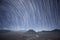 Star tail as light line on night sky by star stax over Bromo volcano