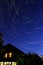Star tracks , house, night sky background. Light