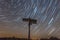 Star trails in the Bavarian Forest in front of a signpost with German place names of the theme hiking trail between Reichenberg an