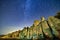 Star trails over rocky cliffside